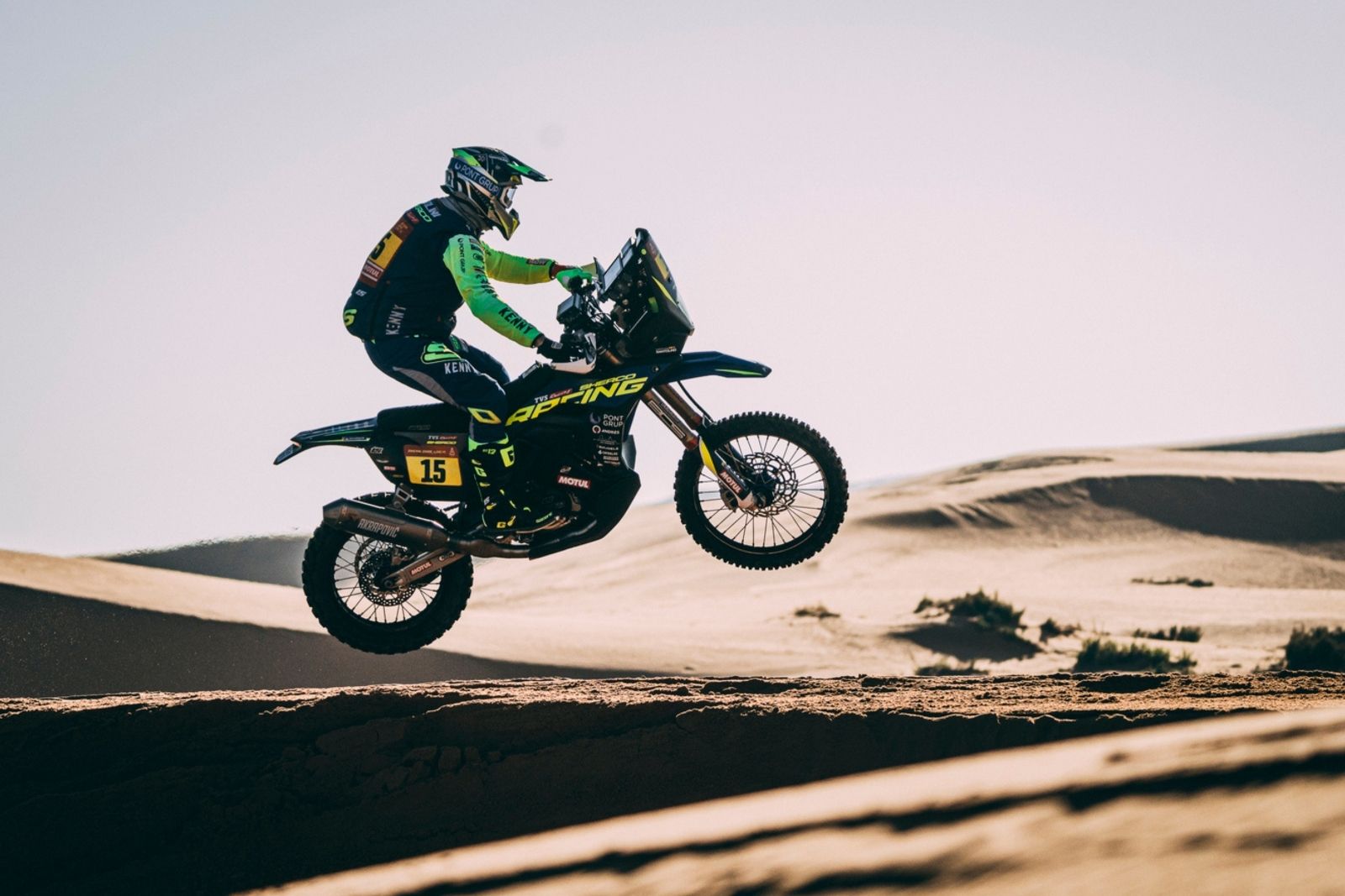 An action shot of a motorbike rider in the air.
