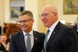 Matt Thistlethwaite smiles for a photo while shaking governor-general David Hurley's hand after being sworn in 