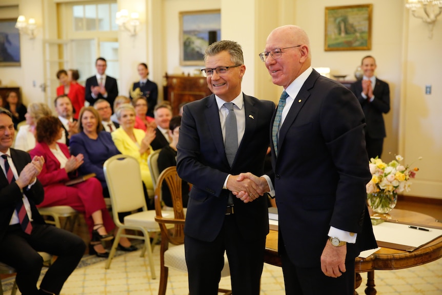 Matt Thistlethwaite smiles for a photo while shaking governor-general David Hurley's hand after being sworn in 