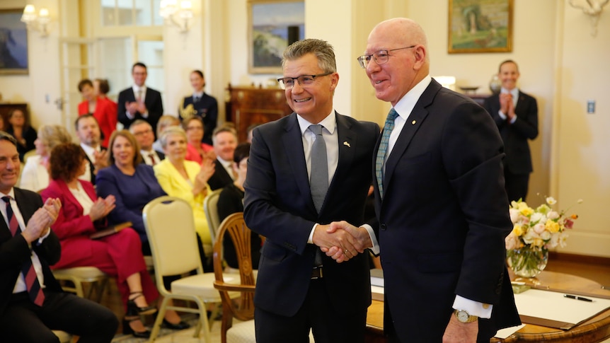 Matt Thistlethwaite smiles for a photo while shaking governor-general David Hurley's hand after being sworn in 