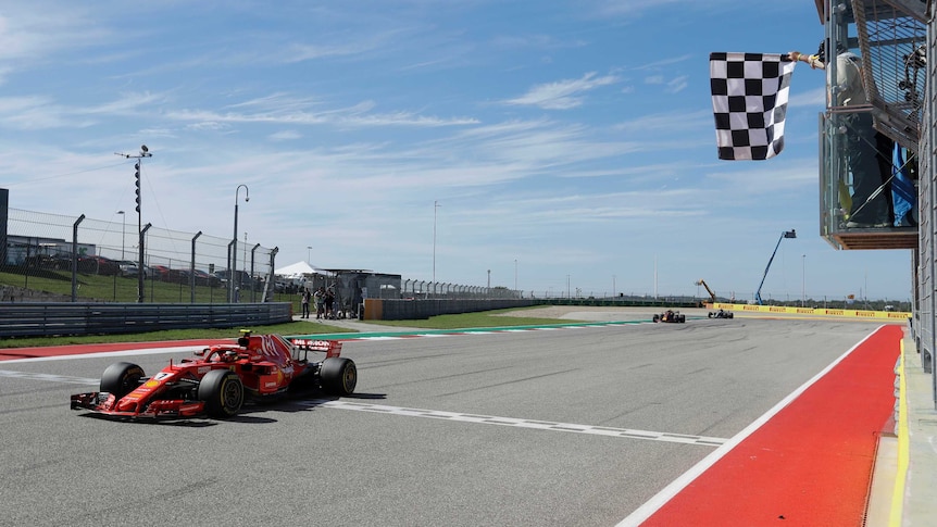 Ferrari driver Kimi Raikkonen takes the checquered flag to win the 2018 US F1 grand prix.