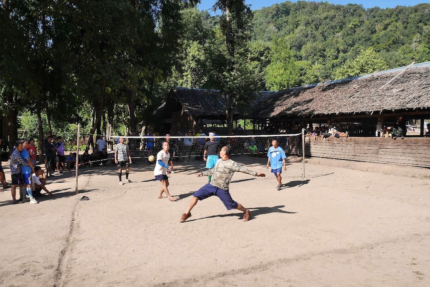 Karen men play caneball in a village in Myanmar.