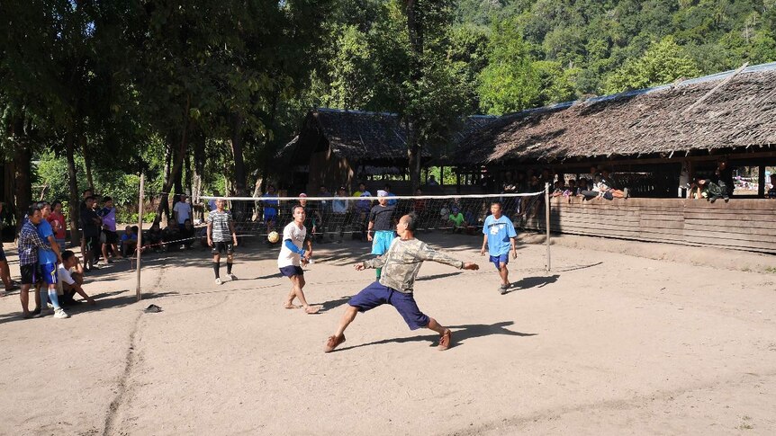 Karen men play caneball in a village in Myanmar.