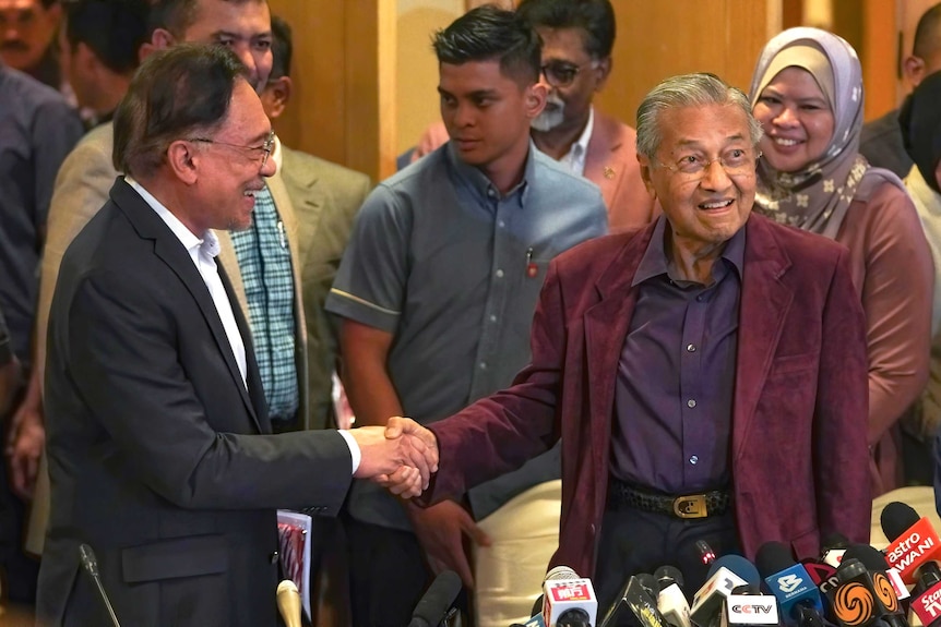 Malaysian Prime Minister Mahathir Mohamad shakes hand with Anwar Ibrahim in Putrajaya, Malaysia.