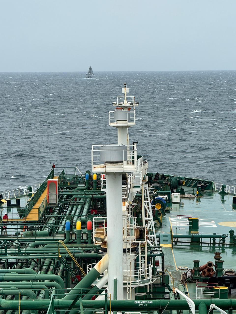 A close up of a ship floating in waters while following another ship.