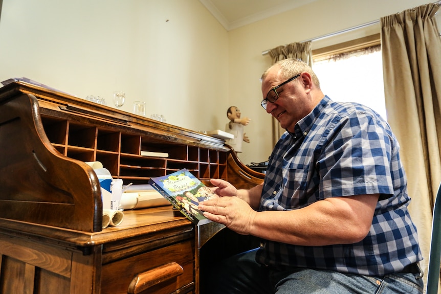 Ex-newsagent from country Victoria Mick Baker with his first self-published novel - Romance Amongst the Roses.