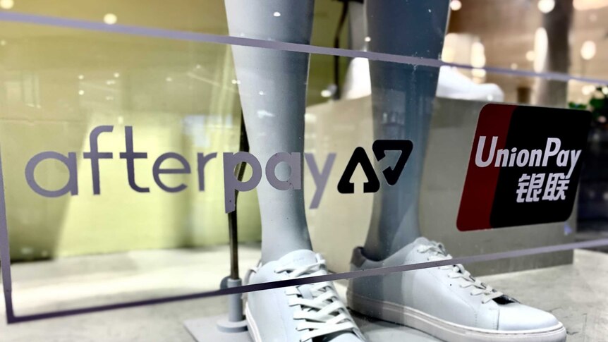 A shop window with signage for Afterpay and UnionPay