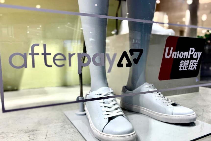 A shop window with signage for Afterpay and UnionPay