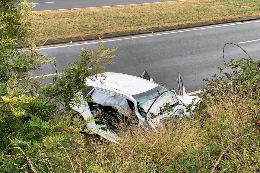 A badly damaged car crashed into a ditch.