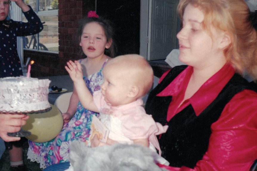 Yolanda Bogert and Kai as a baby wearing a pink dress