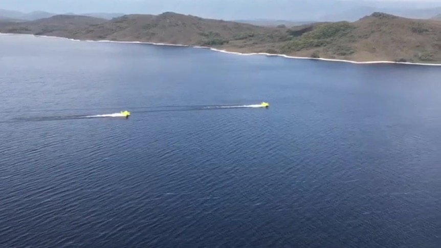 Two Air Tractor 801s scooping water from Lake Pedder to drop over Tasmanian bushfires
