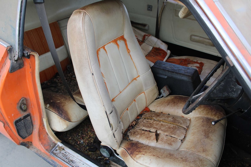 The interior of an old Ford Falcon. It is not in immaculate condition.