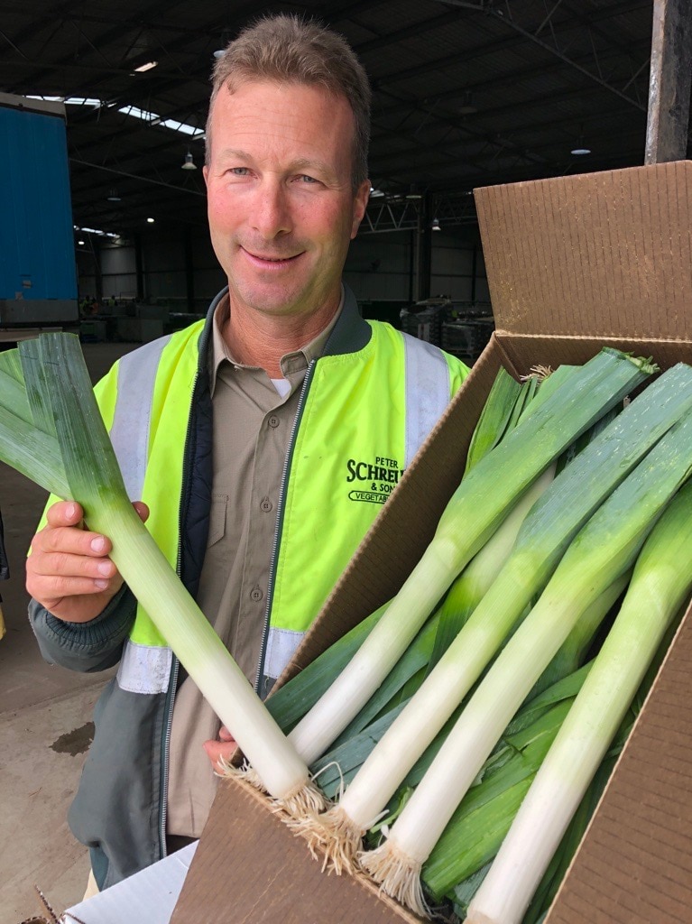 man holds leek