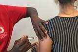 A generic photo of a patient being given a flu shot.