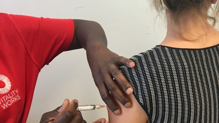 A generic photo of a patient being given a flu shot.