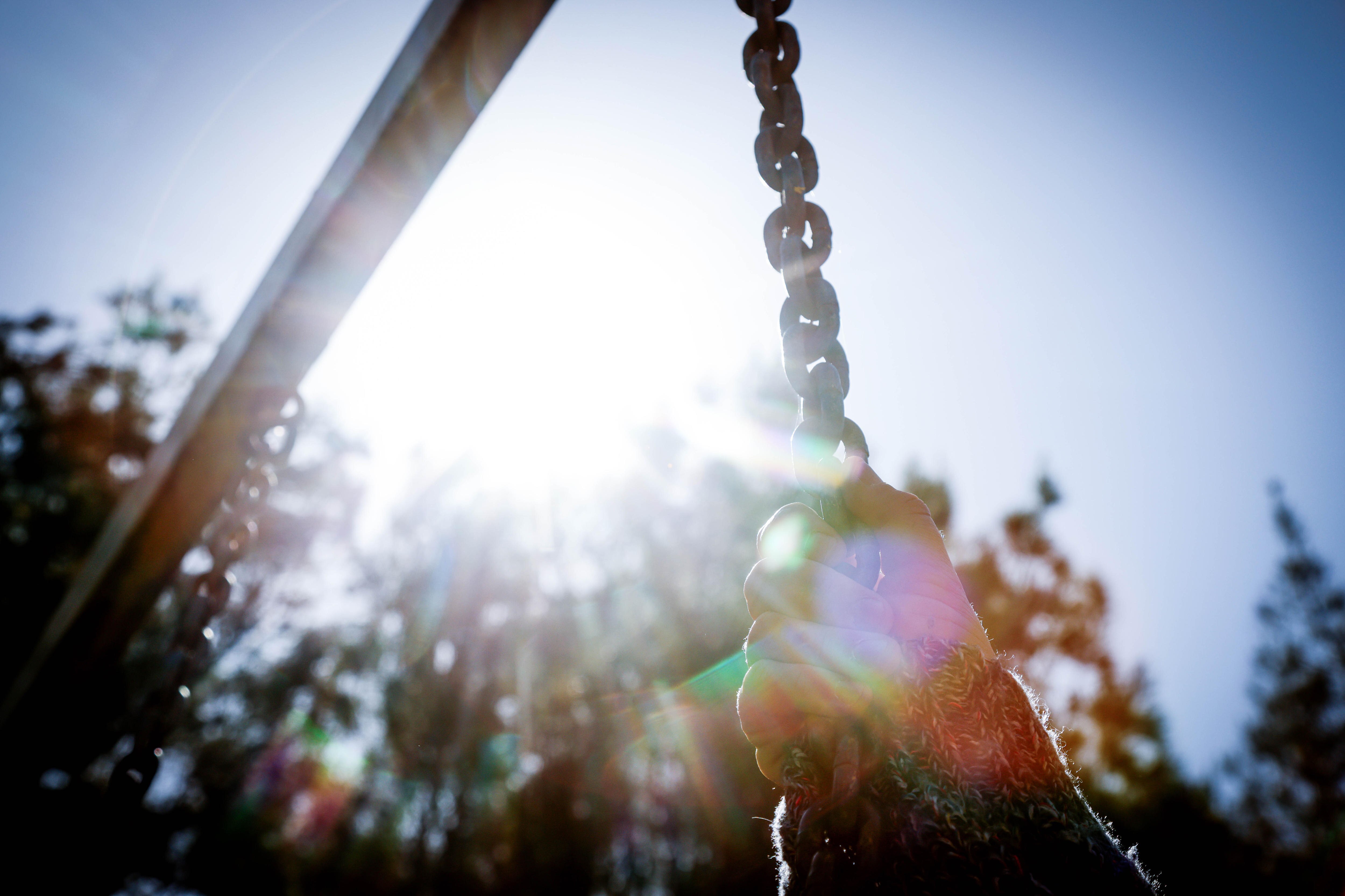 Ella holding on to a swing.