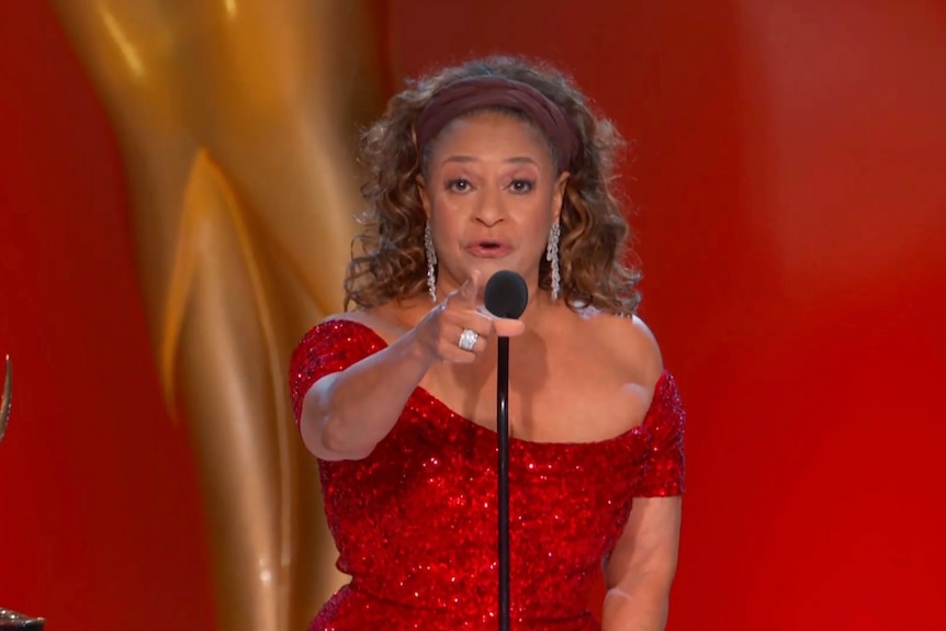 Debbie Allen points as she accepts an Emmy.