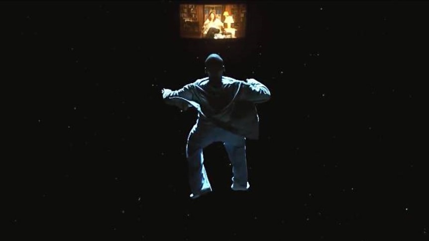 A man floats through space staring at a woman on a distant TV.