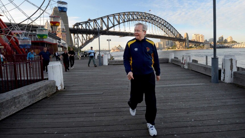 Kevin Rudd takes an early morning walk past Luna Park in Sydney.