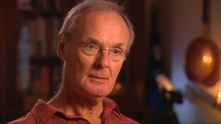 Jeff Watson is shown in an interview screenshot with production lighting and a blurred background