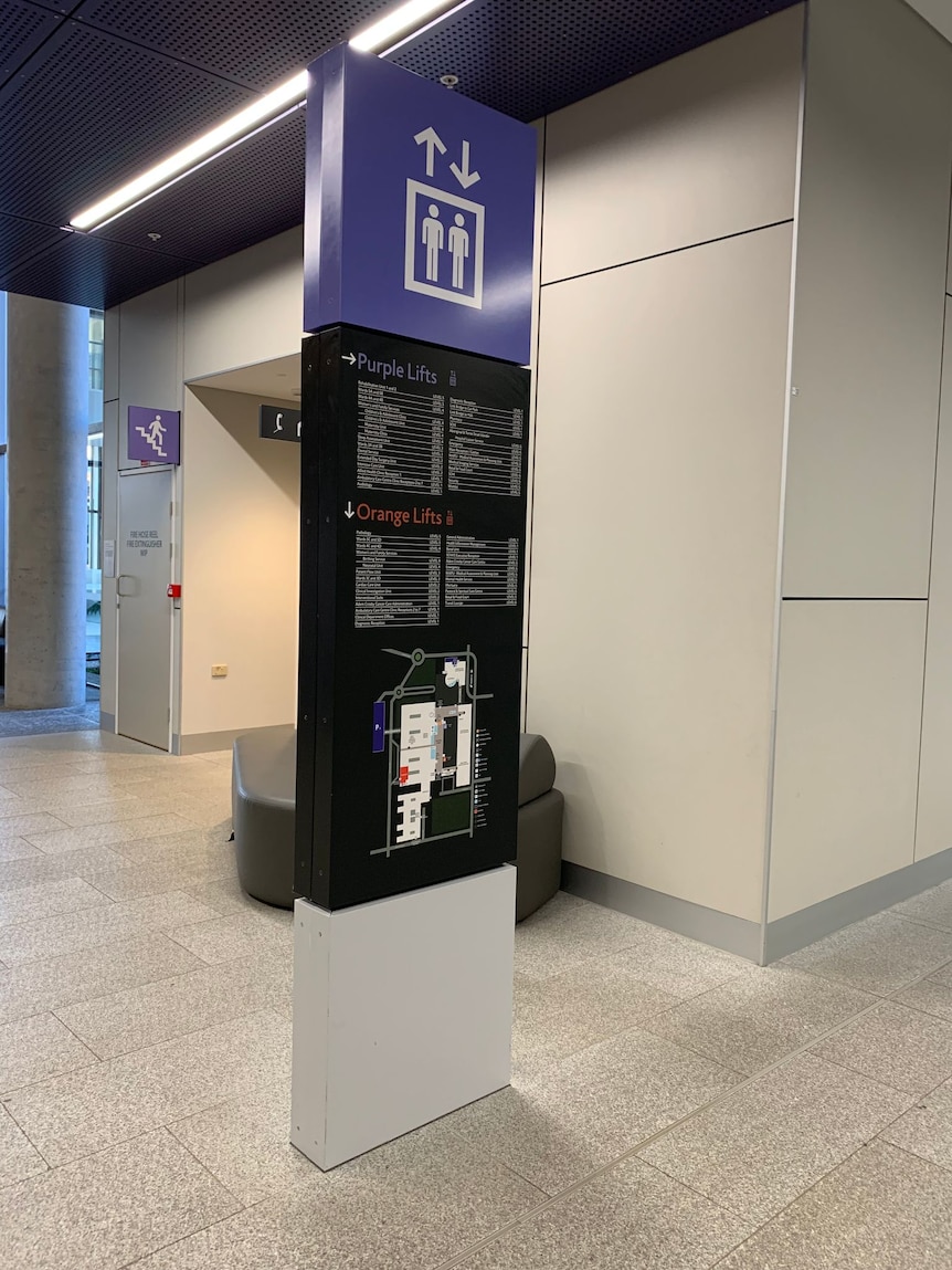 A shot of a purple and black sign inside the hospital