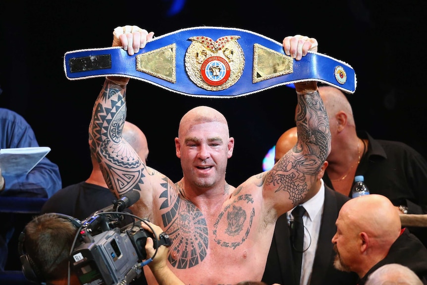 Lucas Browne holding his WBC belt