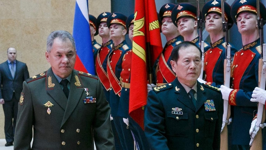 Sergei Shoigu and Wei Fenghe review an honour guard prior to their talks in Moscow.