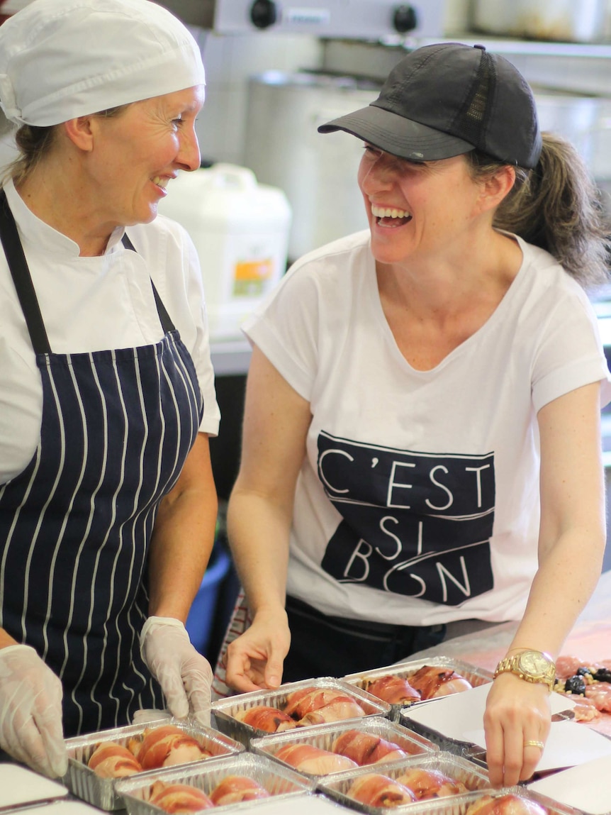 Natasha and her colleague in the kitchen preparing a chicken dish