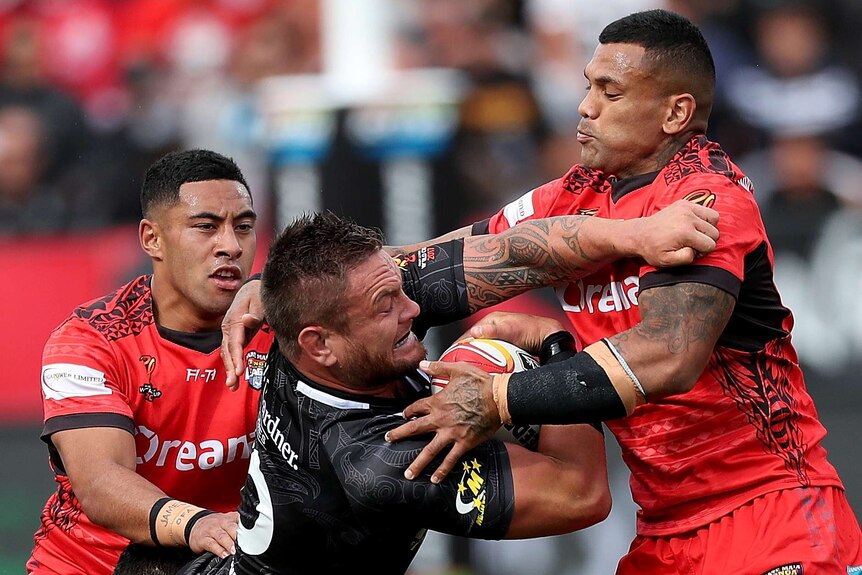 Jared Waerea-Hargreaves being tackled by Manu Ma'u at the Rugby League World Cup.