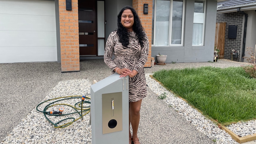 Thuduhena standing outside her newly built home in Berwick, Melbourne. 