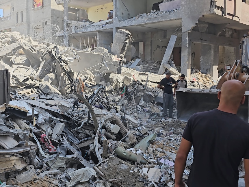 People walk amongst rubble in Gaza.