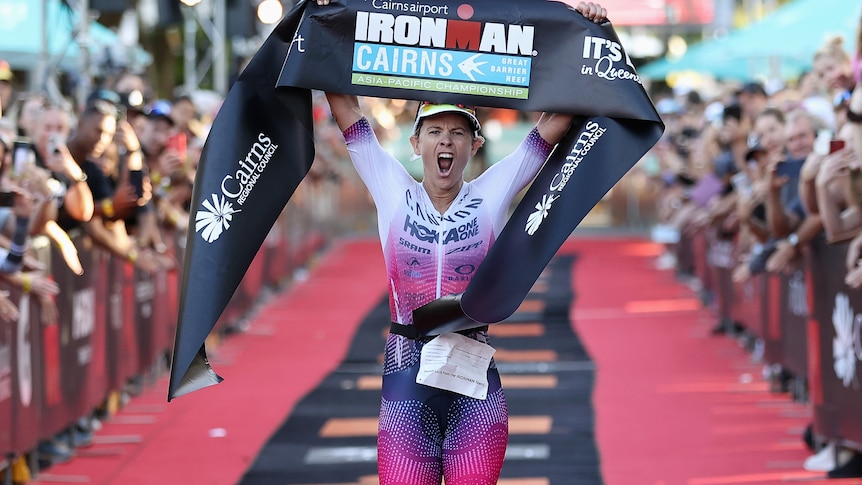 Sarah Crowley roars as she crosses the Ironman Cairns finish line