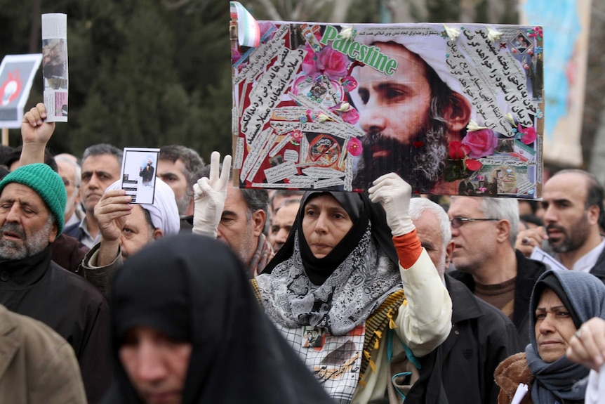 Iranians join a rally to protest the execution of Sheikh Nimr al-Nimr, chanting 'Death to Al Saud'.
