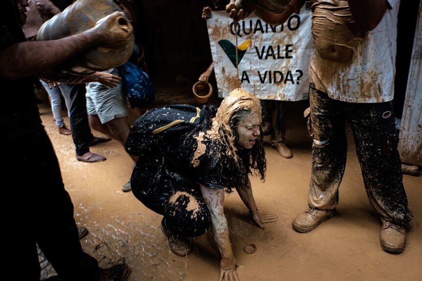 Mud-covered protesters outside Vale's headquarters