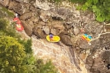 Kayaking party in a river as seen from a helicopter.
