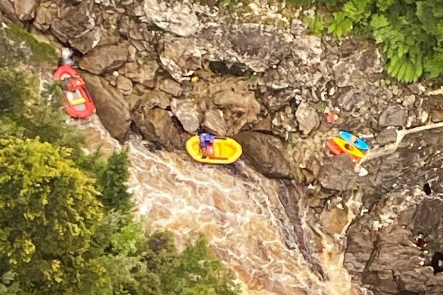 Kayaking party in a river as seen from a helicopter.