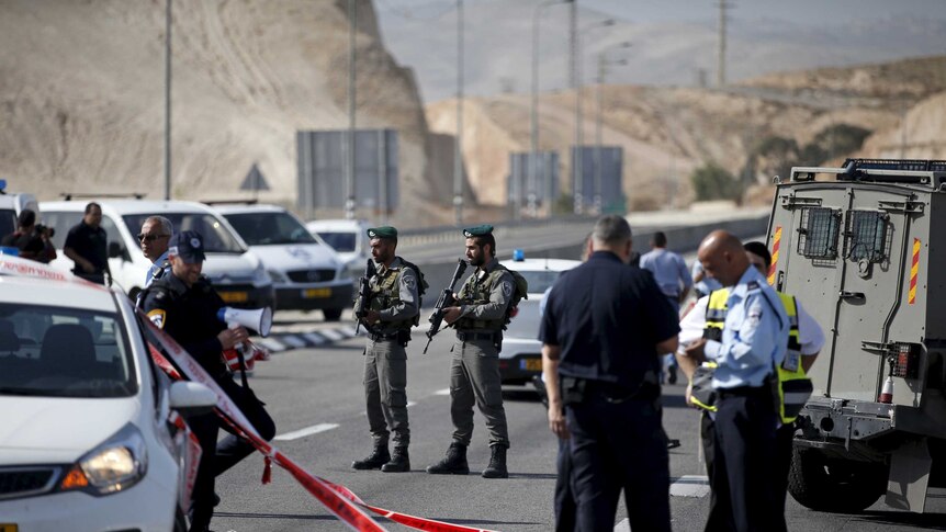 Israeli police officers stand guard at the scene of an attempted car ramming attack in the West Bank.