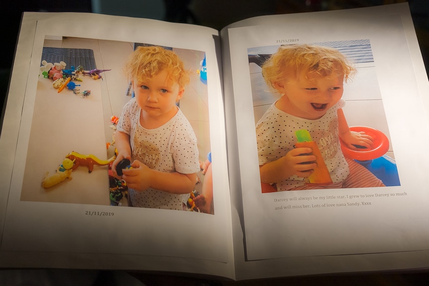 Photos of Darcey smiling in her daycare scrapbook.