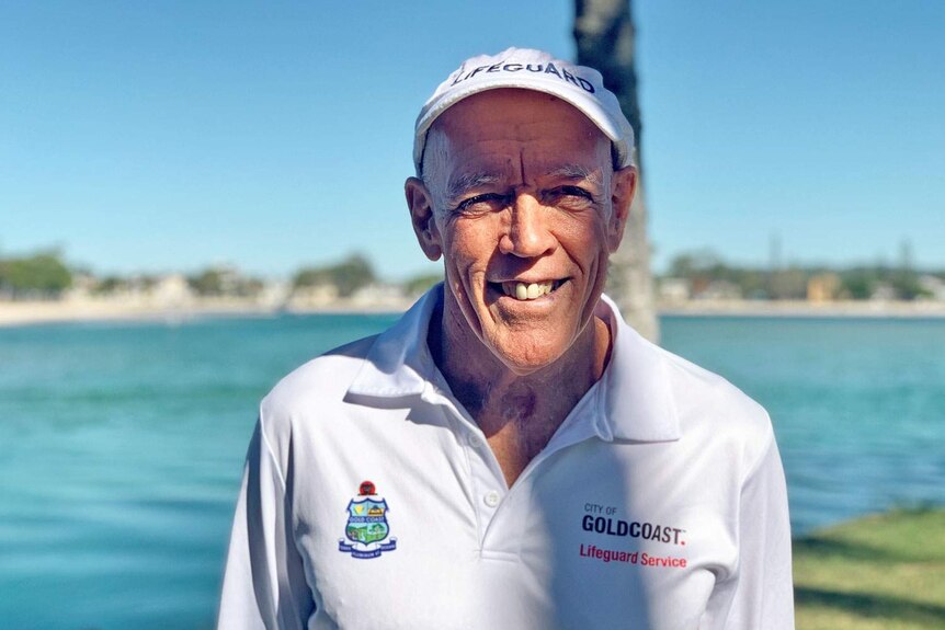Gold Coast Chief Lifeguard Warren Young smiles with the beach behind him.