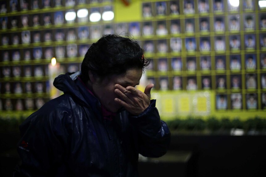 A Korean woman cries at a memorial to the victims of the sinking of the MV Sewol