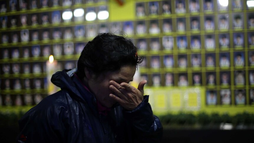 A Korean woman cries at a memorial to the victims of the sinking of the MV Sewol