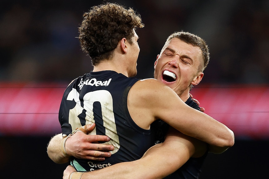 Two Carlton AFL players embrace as they celebrate during a win over Melbourne at the MCG.