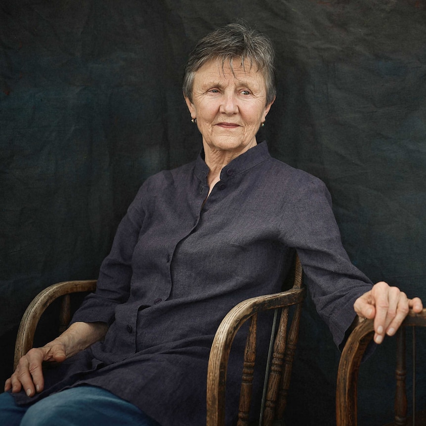 Author photo, Helen Garner seated in a wooden chair