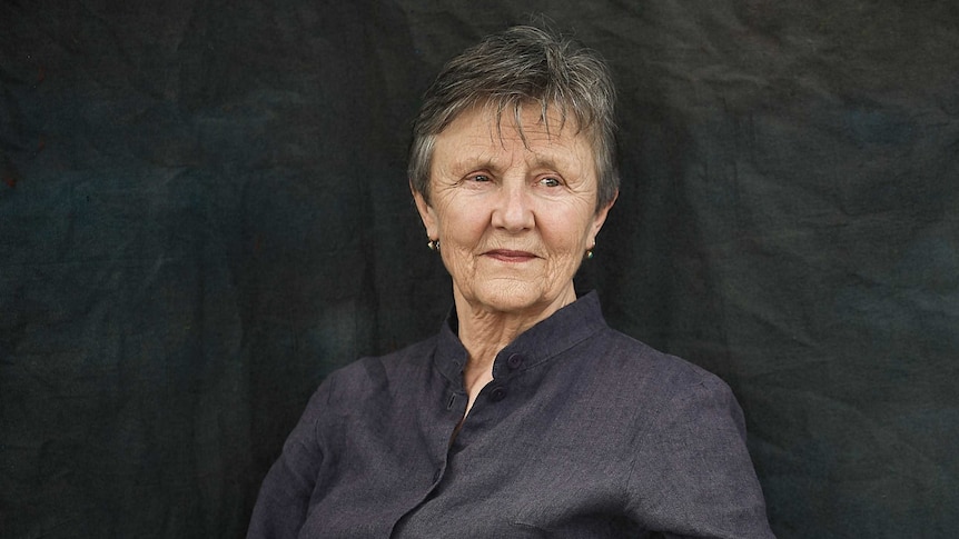 Author photo, Helen Garner seated in a wooden chair