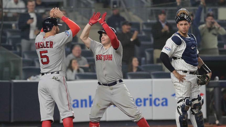 Boston Red Sox's Brock Holt celebrates with Ian Kinsler after hitting a home run.