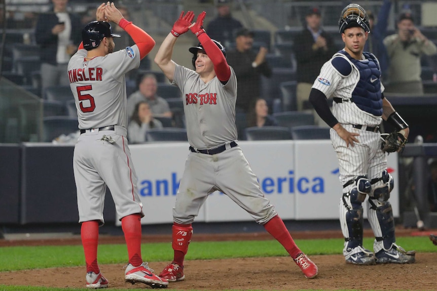 Boston Red Sox's Brock Holt celebrates with Ian Kinsler after hitting a home run.