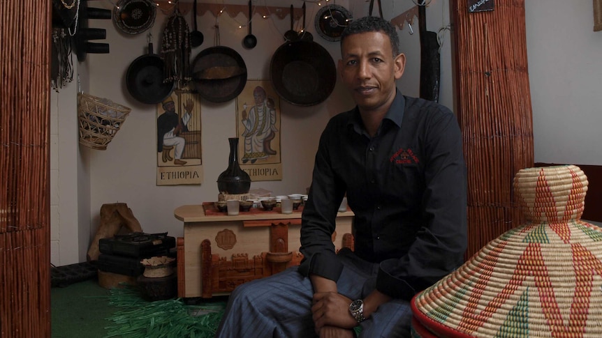 Mohamed Beyan sits at the traditional coffee room in his restaurant