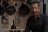 Mohamed Beyan sits at the traditional coffee room in his restaurant