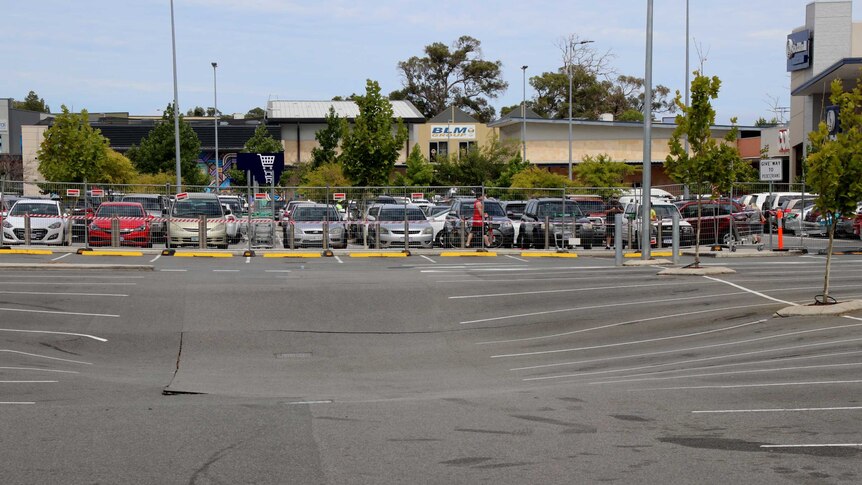 A shopping centre carpark showing subsidence where a sinkhole has appeared.