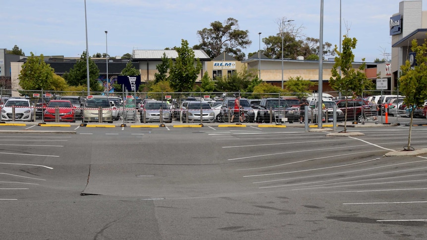 A shopping centre carpark showing subsidence where a sinkhole has appeared.